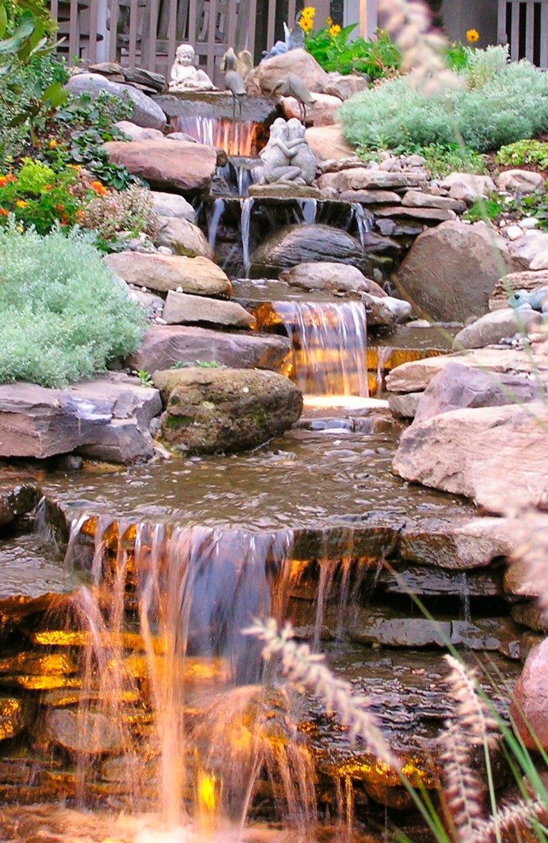 Carefully placed lights underscore the beautiy of a backyard waterfall. Photo courtesy of Pondscapes in Thurmont, Md.