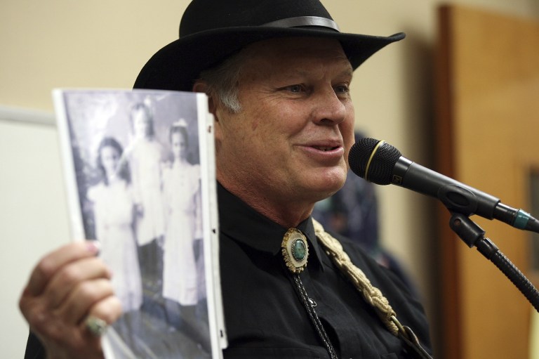   Storyteller and musician Austin Ladd Roberts shows a photograph of his grandmother as he performs for special ed students at the San Antonio LIghthouse for the Blind, Tuesday, Nov. 27, 2012 in San Antonio, Texas. Roberts is part of a traveling troupe of singers and storytellers deployed by the Texas Heritage Music Foundation based in Kerrville. (AP Photo/The San Antonio Express-News, Jerry Lara) RUMBO DE SAN ANTONIO OUT; NO SALES  
