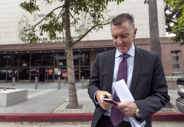 In this June 10, 2014, photo, Los Angeles Unified School District Superintendent John Deasy checks his phone outside the Stanley Mosk Courthouse, before the verdict in the Vergara v. California lawsuit in Los Angeles. Even before a California judge's scathing ruling against the state's teacher tenure policies, protections that make it harder to fire teachers had already been weakened in many states, and even removed altogether in a few places. (AP Photo/Damian Dovarganes)