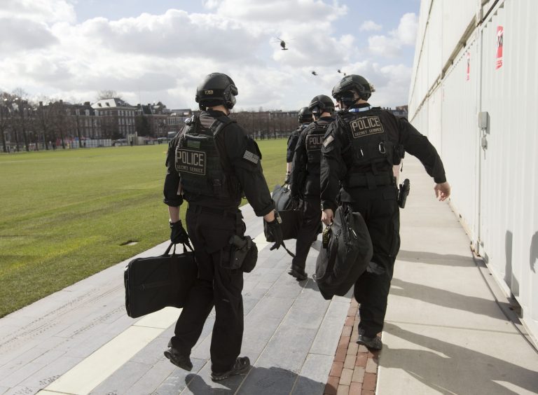 Members of the US Secret Service's Counter Assault Team, known in the agency as CAT, are seen before boarding helicopters at a landing zone in Rijksmuseum in Amsterdam, Netherlands, Monday, March 24, 2014. The Secret Service sent three agents home from the Netherlands just before Obama's arrival after one agent was found inebriated in an Amsterdam hotel, the Secret Service said Tuesday. The three agents were benched for 