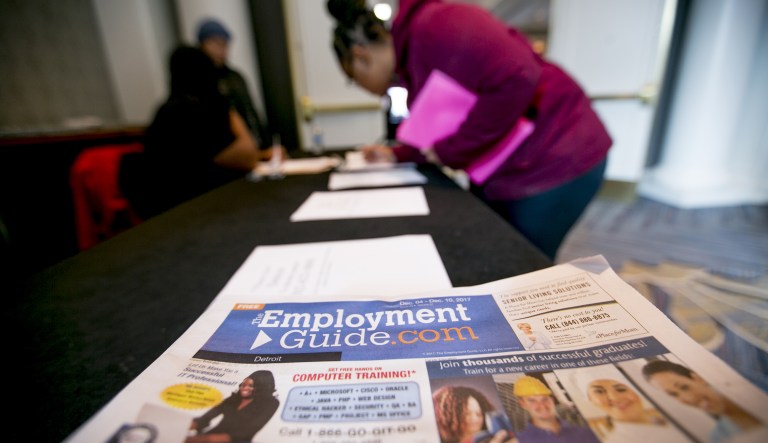 Employment Guide literature sits on a table as a job seeker signs into a National Career Fairs event in Dearborn, Mich., on Tuesday, Dec. 5, 2017. (Anthony Lanzilote/Bloomberg)