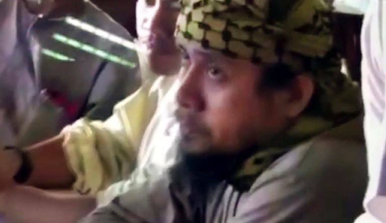 This file image taken from undated shows the purported leader of the Islamic State group's Southeast Asia branch, Isnilon Hapilon, at a meeting of militants at an undisclosed location. Philippine security officials said that Isnilon Hapilon, who is listed among the FBI's most-wanted terror suspects, and Omarkhayam Maute were killed in a gunbattle and their bodies were found Monday, Oct. 16, 2017, in Marawi. (Philippines Military via AP, File)