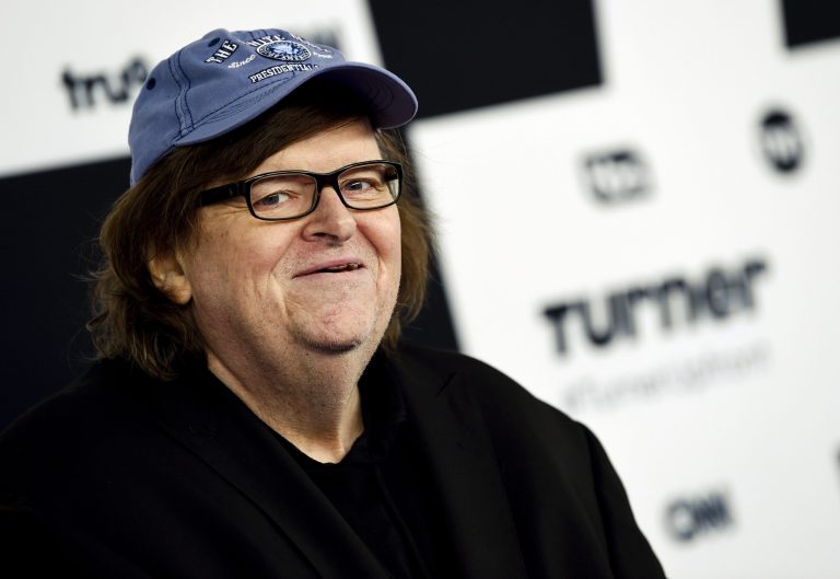 FILE - In this May 17, 2017 file photo, filmmaker Michael Moore attends the Turner Network 2017 Upfront presentation at The Theater at Madison Square Garden in New York. Moore led the audience of his Broadway play to Trump Tower to protest President Donald Trump's comments about the deadly violence in Charlottesville, Va, on Tuesday, Aug. 15. (Photo by Evan Agostini/Invision/AP, File)