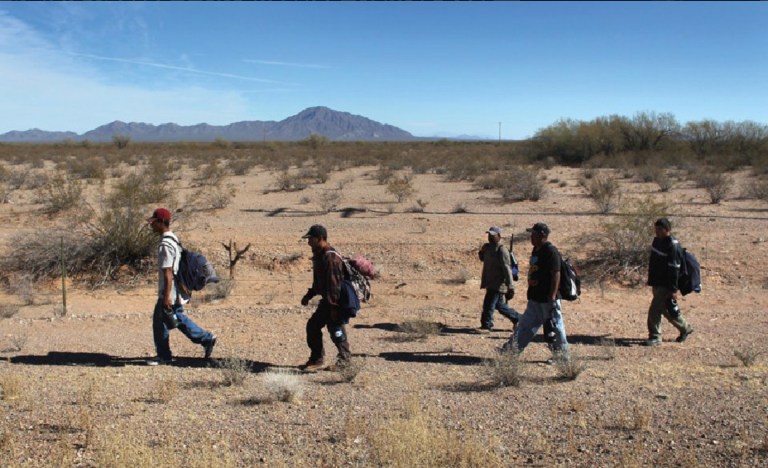 Undocumented Mexican immigrants walk through the Sonoran Desert after illegally crossing the U.S.-Mexico border border into the Tohono O'odham Nation, Arizona. (Getty images/John Moore)