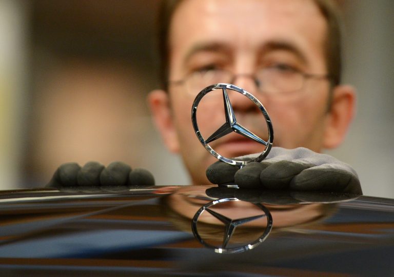 FILE -  In this Jan. 24, 2014 file photo an employee of the Daimler AG mounts the Mercedes star on the hood of a car of the Mercedes S-class at the production line in the Mercedes-Benz production site in Sindelfingen, Germany. Automaker Daimler AG finished 2013 strongly after a rough start to the year that included a profit warning. Net profit fell 36 percent to 1.68 billion euros (US dollar 2.27 billion), reflecting a one-time gain in the fourth quarter of 2012 of 709 million euros from the sale of a stake in aerospace company EADS. With the sale excluded, the company said Thursday, Feb. 6, 2014 that operating earnings jumped 45 percent to 2.53 billion from 1.74 billion. (AP Photo/dpa, Bernd Weissbrod, File)