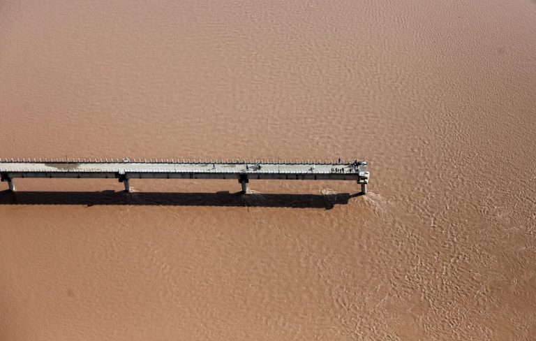An aerial view shows a damaged bridge across the River Tawi at Mandal village on the outskirts of Jammu, India, Monday, Sept. 8, 2014. Six days of rains in Indian Kashmir have left more than 120 people dead in the region's worst flooding in more than five decades, submerging hundreds of villages and triggering landslides, officials said. (AP Photo/Channi Anand)