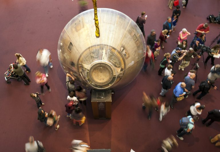 Visitors walk around the Apollo 11 capsule at the Smithsonian's Air and Space Museum after it opened on time, in Washington, Thursday, Oct. 17, 2013. Barriers went down at federal memorials, National Park Service sites, as well as the Smithsonian Institution's network of popular museums and thousands of furloughed federal workers returned to work across the country Thursday after 16 days off the job due to the partial government shutdown. (AP Photo/Cliff Owen)