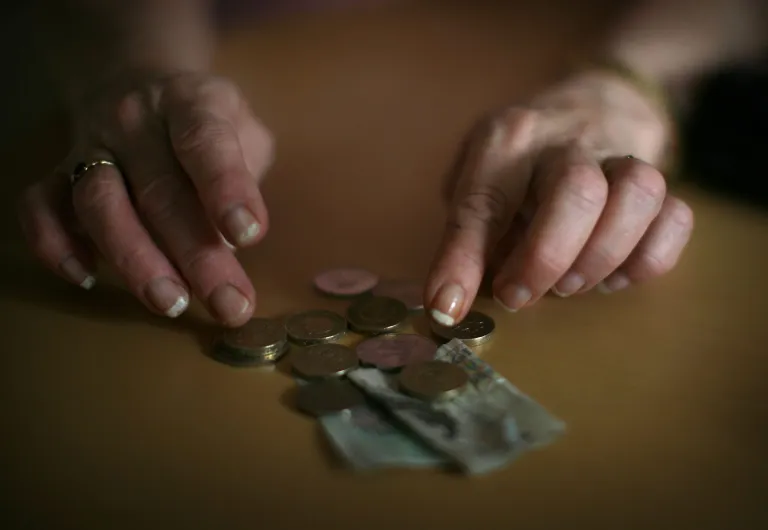 In this photo illustration an old age pensioner checks what is left of her weekly state pension on November 6, 2008, in Conwy, Wales. (Photo by Christopher Furlong/Getty Images)