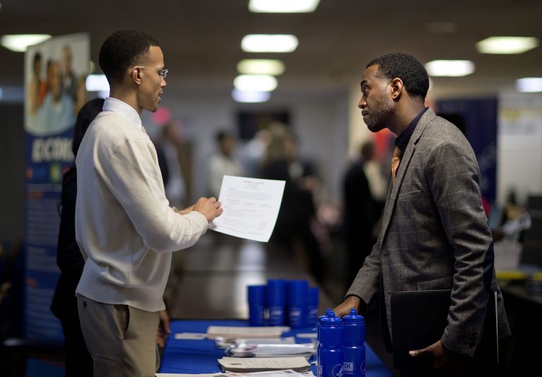 FILE - In this , Thursday, Nov. 14, 2013, file photo, retired U.S. Air Force Master Sgt. Thomas Gipson, of Atlanta, right, has his resume looked over by Ralph Brown, a management and program analyst with the Centers for Disease Control and Prevention, during a job fair for veterans at the VFW Post 2681, in Marietta, Ga. The government reports on job openings and labor turnover for September on Friday, Nov. 22, 2013. (AP Photo/David Goldman, file)