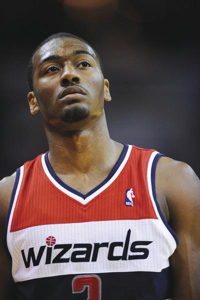 Nick Wass/AP
John Wall and the Wizards had little to be happy about during Friday's 103-78 loss to Philadelphia in the preseason opener.