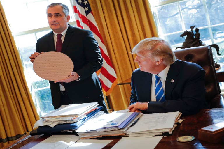 President Donald Trump looks at Intel CEO Brian Krzanich, left, holding a silicon wafer during their meeting in the Oval Office. The tech firm plans to add 3,000 high-skilled jobs in Arizona plant and 7,000 jobs in the supply chain. (AP Photo/Pablo Martinez Monsivais)