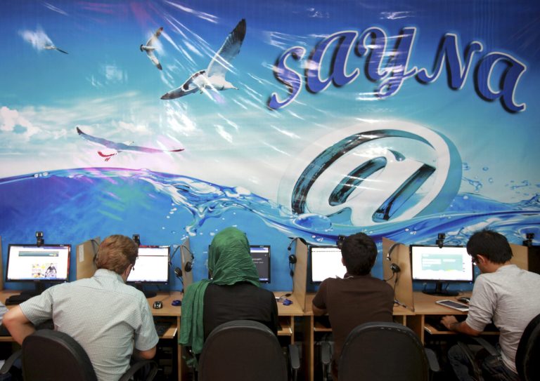 FILE - In this Tuesday, Sept, 17, 2013 file photo, Iranians surf the Internet at a cafe in Tehran, Iran. On Monday, Sept. 1, 2014 Iranian President Hassan Rouhani urged the country's clerics to be more tolerant of the Internet and new technologies, which are often the target of criticism by influential hard-liners in the Islamic Republic. Rouhani made the appeal during a meeting with clerics in Tehran, where he said that the Internet is important for aspiring students and experts trying to access new knowledge and science. (AP Photo/Ebrahim Noroozi, File)