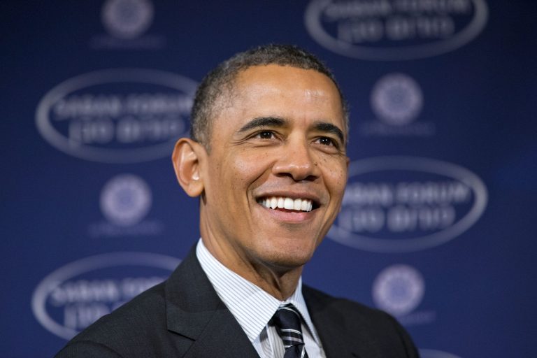 FILE - In this Dec. 7, 2013 file photo, President Barack Obama smiles as he arrives at the  Saban Forum to speak about the Middle East at the Willard Hotel in Washington. Obama's approval ratings for handling foreign policy issues generally top his ratings for most domestic issues, including the economy and health care, according to a new Associated Press-GfK poll. But the poll also suggests a majority of Americans want the president to pull troops out of Afghanistan faster than he's doing, and many are skeptical about a tentative nuclear deal with Iran.  (AP Photo/Jacquelyn Martin)