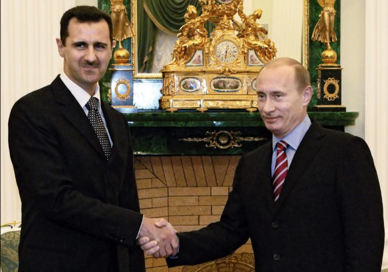   FILE - In this Tuesday, Dec. 19, 2006 file photo Vladimir Putin, then Russian President, right, and his Syrian counterpart Bashar Assad smile as they shake hands in Moscow's Kremlin. With even his most powerful ally, Russia, losing faith in him, President Bashar Assad may appear to be heading for a last stand against rebel forces who have been waging a ferocious battle to overthrow him for nearly two years. But Assad still has thousands of elite and loyal troops behind him, and analysts say that even if he wanted to give up the fight, it's unclear those around him would let him abandon ship and leave them to an uncertain fate.(AP photo/RIA Novosti, Mikhail Klimentyev, Presidential Press service, File)  
