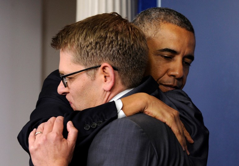 President Obama gives White House press secretary Jay Carney a hug after announcing that Carney will step down later next month, during a surprise visit to the Brady Press Briefing Room of the White House, Friday, May 30, 2014. (AP Photo/Susan Walsh)
