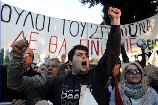 Protesters chant slogans outside the Cypriot parliament against a crucial parliamentary vote on a plan to seize a part of depositors' bank savings in central Nicosia on Tuesday. (AP Photo/Petros Giannakouris)