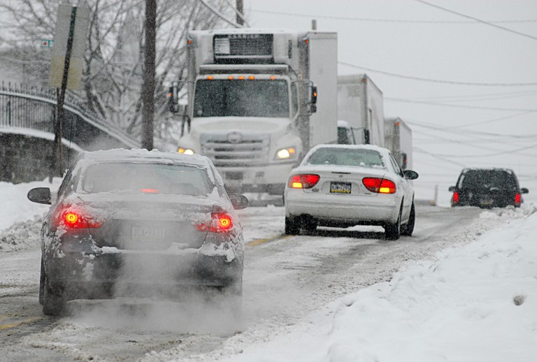   Cars drive through a winter snow storm, Saturday, Dec. 29, 2012. on South Main Street in Pittston, Pa. Snow from a mild but widespread winter storm began falling Saturday over most of the Northeast and the upper Ohio River Valley, the second in less than a week for the regions. (AP Photo/The Citizens' Voice, Ralph Francello) MANDATORY CREDIT  
