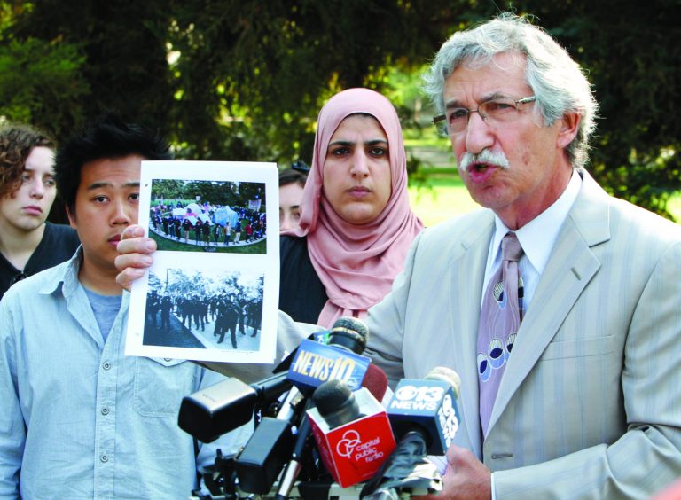 Attorney Mark Merin, who represented the University California, Davis, students who were pepper-sprayed last November, discusses the settlement between the the school and students during a news conference at UC Davis in Davis, Calif., Wednesday, Sept. 26, 2012. Included in the terms of the settlement were that UC Davis Chancellor Linda Katehi will issue a formal written apology to each of the 21 students and recent alumni who was pepper sprayed or arrested and they will receive $30,000 from the $1 million settlement. Seen in the background are Ian Lee, left, and Fatima Sbeih, who were both peppered-sprayed.(AP Photo/Rich Pedroncelli)