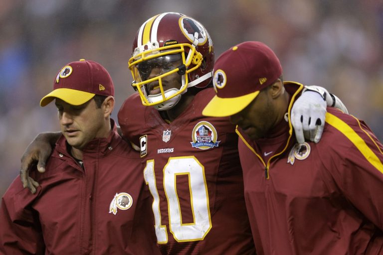 Robert Griffin III is carried off the field during Sunday's game. (Patrick Semansky/AP)