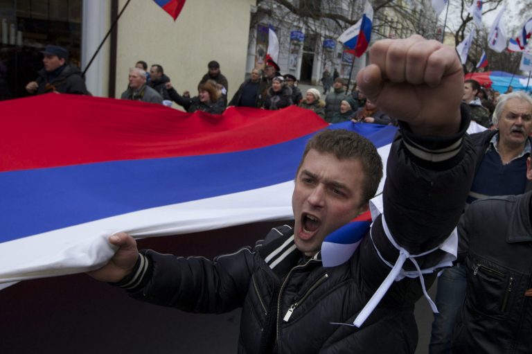 Local residents carry Russian flags and shout slogans while rallying through the streets of the Crimean capital Simferopol in Ukraine on Saturday. (AP Photo/Ivan Sekretarev)
