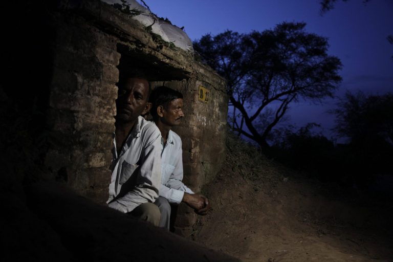 Indian villagers take shelter inside an army bunker anticipating firing from the Pakistan side of the border at Abdullian village in Ranbir Singh Pura, in Jammu and Kashmir state, India, Monday, Aug. 25, 2014. Indian and Pakistani forces exchanged gunfire and mortar rounds in the disputed Kashmir region for a second straight night on Saturday, after two villagers were killed on each side in an exchange Friday night. (AP Photo/Channi Anand)