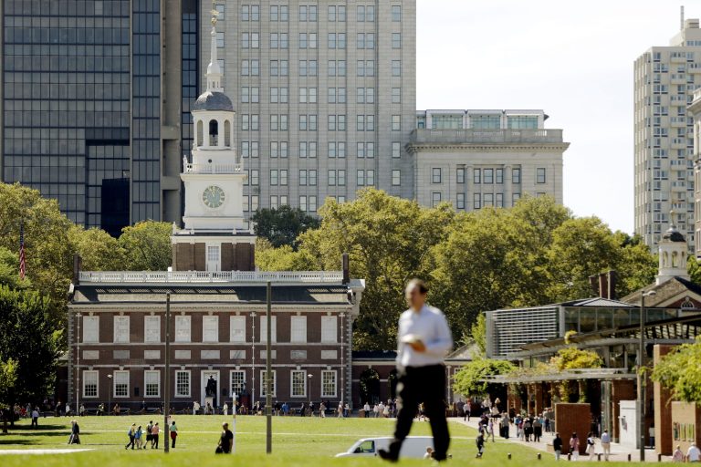   A man walks past Independence Hall at Independence National Historical Park in Philadelphia, Monday, Sept. 30, 2013 as the government teeters on the brink of a partial shutdown at midnight unless Congress can reach an agreement on funding. A conservative challenge to President Barack Obama's cherished health care law pushed the federal government to the brink of a partial shutdown Monday, with the Senate expected to convene just hours before a deadline to pass a temporary spending bill. If no compromise can be reached by midnight, Americans would soon see the impact: National parks would close. (AP Photo/Matt Rourke)  