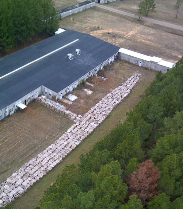   This aerial photo provided by the Louisiana State Police shows part of the smokeless explosive powder improperly stored outside Explo Systems Inc., a munitions dismantling facility at Camp Minden at Doyline, La. Police moved millions of pounds of explosives Monday that had been haphazardly stashed in warehouses in Louisiana, prompting hundreds to evacuate from harm's way in case any of it exploded. About half the 800 residents in nearby Doyline, about 40 miles south of the Arkansas line, heeded state police warnings to evacuate until the stash could be divided into smaller quantities. (AP Photo/Louisiana State Police via The ( Shreveport ) Times)  