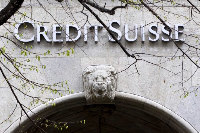 FILE - In this April 3, 2012 file picture the logo of Swiss bank Credit Suisse is photographed at a building in Zurich. Credit Suisse Group says it is raising 8.7 billion Swiss francs (US $8.9 billion) to bolster its capital reserves.  The Swiss bank says 3.8 billion francs come from the placement of so-called contingent convertible bonds underwritten by investors from Qatar, Saudi Arabia and Singapore.  The Zurich-based bank's announced WednesdayJuly 18, 2012 that its second-quarter earnings attributable to shareholders increased 2.6 percent to 788 million francs.  (AP Photo/Keystone/Alessandro Della Bella,File)
