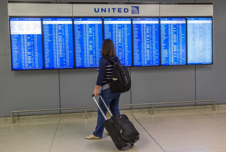 A traveler looks at a flight departure board Monday, Sept. 29, 2014 at O'Hare International Airport in Chicago. The Federal Aviation Administration said Monday it is reviewing security practices and how it deals with unexpected incidents throughout its air traffic control facilities following last week's fire at a Chicago-area air traffic facility. (AP Photo/Teresa Crawford)