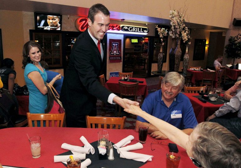   Republican congressional candidate Jesse Kelly greets supporters as he arrives for a post-election night event Tuesday, June 12, 2012, in Tucson, Ariz. Kelly is running against Democrat Ron Barber, Gabrielle Giffords' former district director, for the seat Giffords left in January to focus on her recovery from a gunshot wound to her head during a gunman's shooting spree a year earlier. (AP Photo/Ross D. Franklin)  