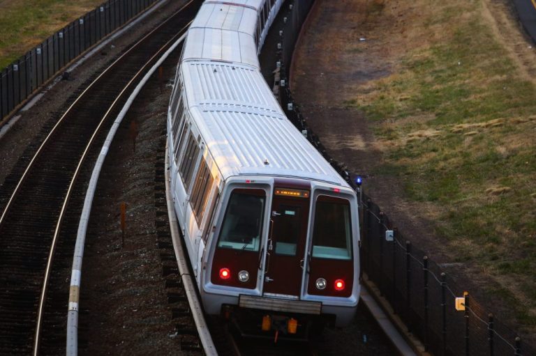 A metro train travels westbound along interstate 66.