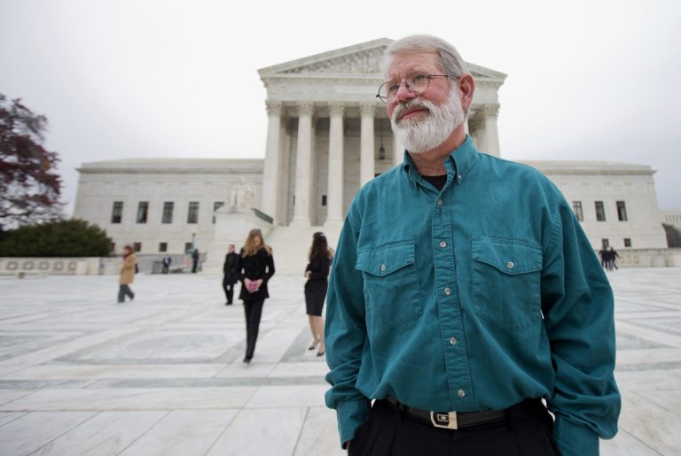 John Dennis Apel, stands in front of the Supreme Court in Washington, Wednesday, Dec. 4, 2013, following an argument on the right to protest at a military base. Apel had been barred from entering any part of Vandenberg Air Force Base on the central California coast, including the protest area on a public highway that passes near the main gate.  (AP Photo/Manuel Balce Ceneta)