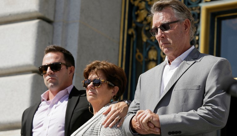 File - In this Sept. 1, 2015 file photo, from left, Brad Steinle, Liz Sullivan and Jim Steinle, the brother, mother and father of Kate Steinle who was shot to death on a pier, listen to their attorneys speak during a news conference on the steps of City Hall in San Francisco. The parents of a woman killed on a San Francisco pier by a man in the country illegally is suing the city and two federal agencies that they say contributed to her death. Kate Steinle's parents filed the wrongful-death lawsuit Friday, May 27, 2016. It accuses the San Francisco Sheriff's Department of failing to notify federal immigration officials that it was releasing Juan Francisco Lopez-Sanchez from jail. (AP Photo/Eric Risberg, File)