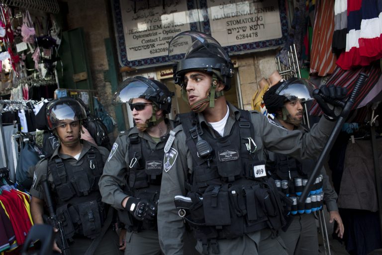 Israeli Border Police take position during clashes in Jerusalem's Old City, Tuesday, April 2, 2013. Clashes erupted during a protest in support of Maysara Abu Hamdiyeh, 64, who was serving a life sentence for his role in a foiled attempt to bomb a busy cafe in Jerusalem in 2002, and died Tuesday of cancer in an Israeli jail. Tensions are high in Israeli lockups where thousands of Palestinian security prisoners are being held. (AP Photo/Bernat Armangue)