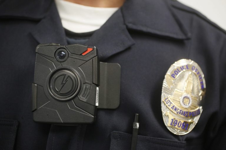 A Los Angeles Police officer wears on-body cameras during a demonstration for media in Los Angeles on Jan. 15. (AP Photo/Damian Dovarganes)