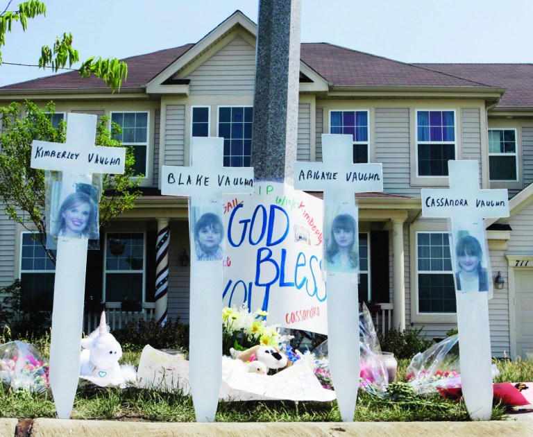 FILE - In this June 15, 2007 file photo, a makeshift memorial to Kimberly Vaughn, and her three children Abigayle, 12, Cassandra, 11, and Blake, 8, is seen outside their home in Oswego, Ill. Closing statements are scheduled to begin Thursday, Sept. 20, 2012, in Joliet, Ill., in the murder trial for Christopher Vaughn, accused of shooting dead his wife Kimberly and three kids as the family drove to a waterpark in 2007. (AP Photo/Charles Rex Arbogast, File)