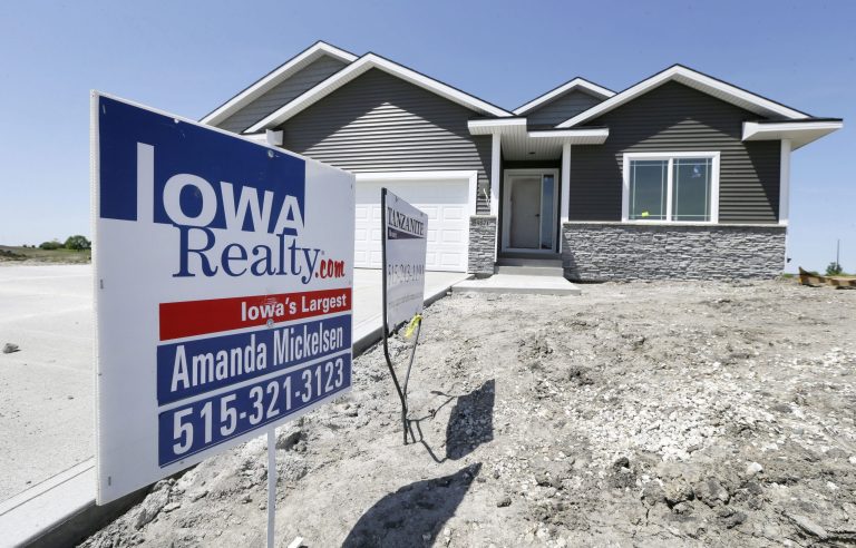 In this May 21, 2014 photo, a sign sits in front of a new home for sale in West Des Moines, Iowa.  The Commerce Department reports on sales of new homes in April on Friday, May 23, 2014.