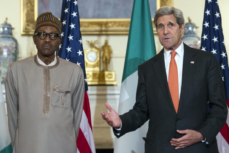 Secretary of State John Kerry gestures while he and Nigerian President Muhammadu Buhari make statements prior to a working lunch at the State Department in Washington, Tuesday, July 21, 2015. (AP Photo/Cliff Owen)