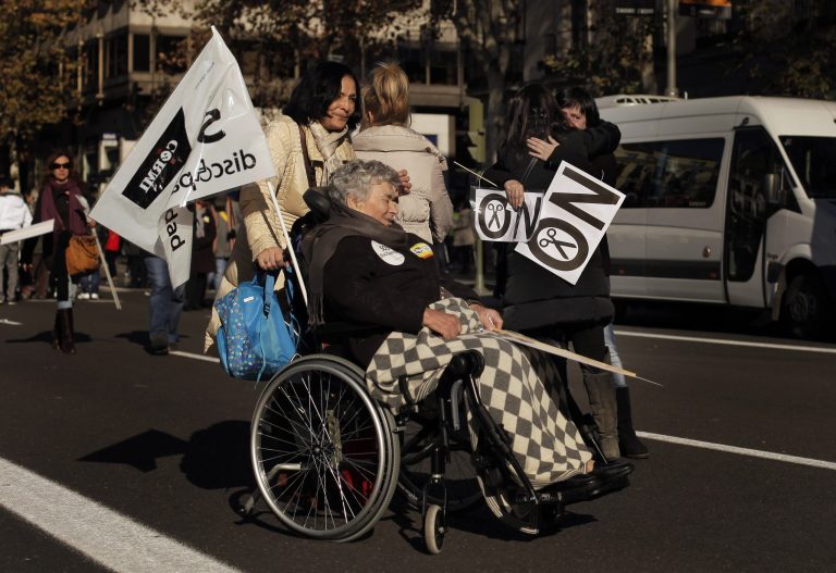   People gesture as they carry banners reading, 