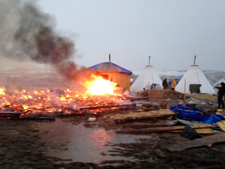 Dakota Access pipeline opponents burn structures in their main protest camp in southern North Dakota near Cannon Ball, N.D., on Wednesday, Feb. 22, 2017, as authorities prepare to shut down the camp in advance of spring flooding season. (AP Photo/James MacPherson)