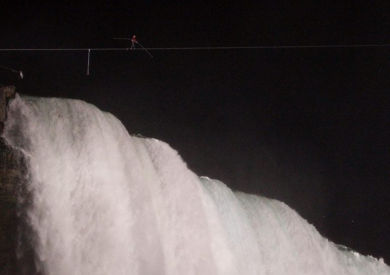   Nik Wallenda walks across Niagara Falls on a tightrope as seen from Niagara Falls, N.Y., Friday, June 15, 2012. Wallenda has finished his attempt to become the first person to walk on a tightrope 1,800 feet across the mist-fogged brink of roaring Niagara Falls. The seventh-generation member of the famed Flying Wallendas had long dreamed of pulling off the stunt, never before attempted. (AP Photo/James P. McCoy)  