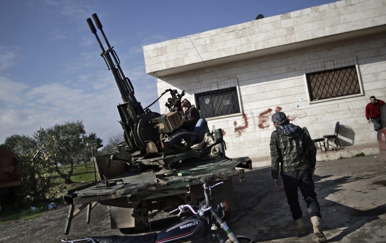 FILE - In this Friday, Dec. 14, 2012 file photo, a Syrian rebel checks an anti-aircraft weapon, in Maaret Misreen, near Idlib, Syria. America's Arab allies have dramatically stepped up weapon supplies to Syrian rebels in preparation for a push on the capital Damascus, the main stronghold of President Bashar Assad, officials and Western military experts say, with one official saying airlifts to neighboring Jordan and Turkey have doubled the past month. The U.S. and other Western governments are involved to channel the flow toward more secular fighters, they say. The influx appears to be boosting a rebel drive to seize supply routes from the border with Jordan to Damascus. (AP Photo/Muhammed Muheisen, File)