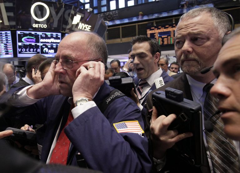   In an April 12, 2012 file photo traders Frederick Reimer, left, Gregory Rowe, center, and Robert Moran, second from right, work on the floor of the New York Stock Exchange. U.S. futures augured a lower open on Wall Street Friday June 8, 2012. Dow Jones industrial futures fell 0.7 percent to 12,316 and S&P 500 futures lost 0.8 percent at 1,299.60. (AP Photo/Richard Drew)  