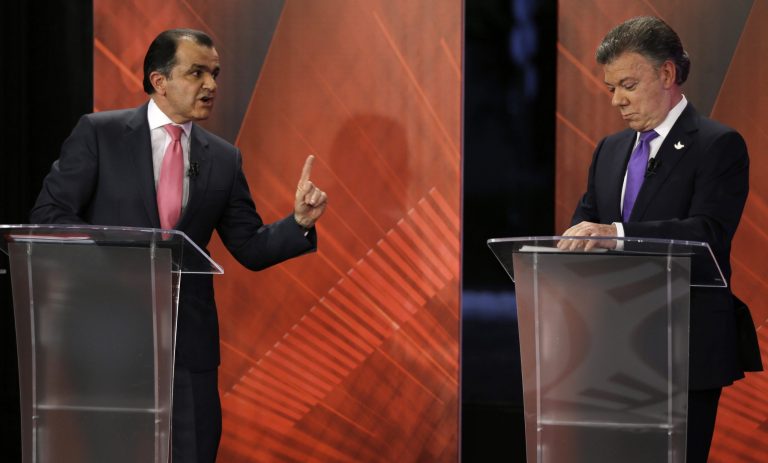 Presidential candidate Oscar Ivan Zuluaga, left, points as he faces Colombia's President Juan Manuel Santos during a televised debate in Bogota, Colombia, in this June 9, 2014 file photo. (AP Photo/Fernando Vergara, File)