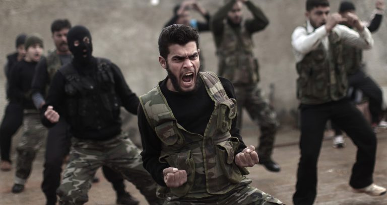   In this Monday, Dec. 17, 2012 photo, Syrian rebels attend a training session in Maaret Ikhwan, near Idlib, Syria.The new Syrian rebel chief, a defected army general who spent months in exile, says he has begun operating inside Syria to unite autonomous anti-regime militias for what he hopes will be the final push against President Bashar Assad. (AP Photo/Muhammed Muheisen)  