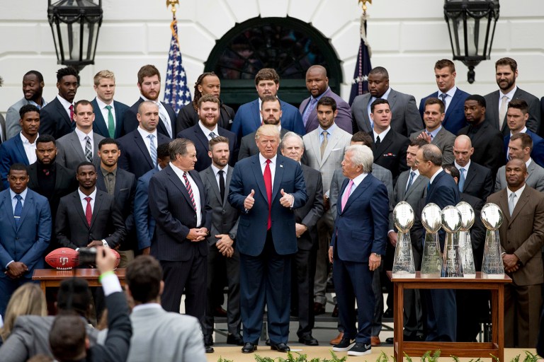 President Trump stands with New England Patriots head coach Bill Belichick, left, owner Robert Kraft, right, and team members during a ceremony at the White House. (AP Photo/Andrew Harnik)