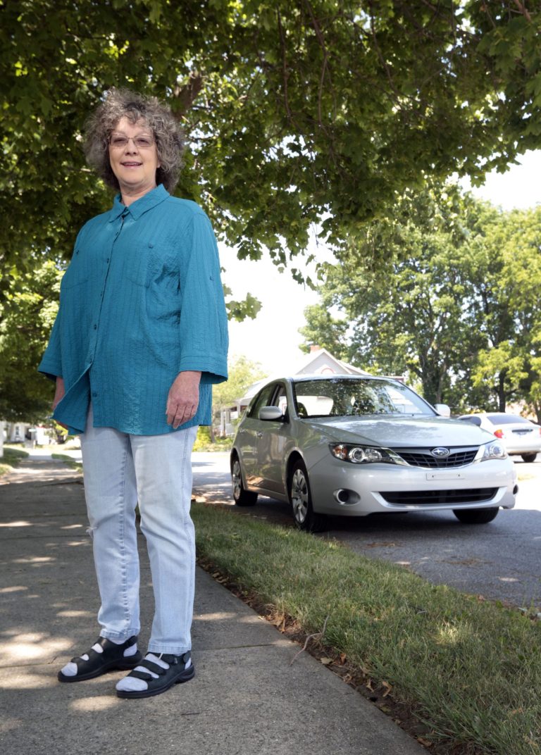   Cindy Shriner, a retired teacher, poses for a portrait with her 2009 Subaru Impreza in Lafayette, Ind., Saturday, June 9, 2012. Shriner buys energy-efficient light bulbs and her car gets nearly 30 miles per gallon on the highway. Still, she keeps her house at about 73 degrees year-round, despite government recommendations to turn thermostats to 68 degrees in winter and 78 degrees in summer. 