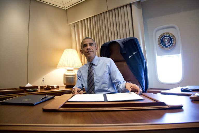 President Barack Obama looks up after signing two presidential memoranda associated with his executive actions on immigration in his office on Air Force One as he arrives at McCarran International Airport in Las Vegas, Friday, Nov. 21, 2014, as he travels to Del Sol High School to speaks about the steps he will be taking on immigration. (AP Photo/Carolyn Kaster)