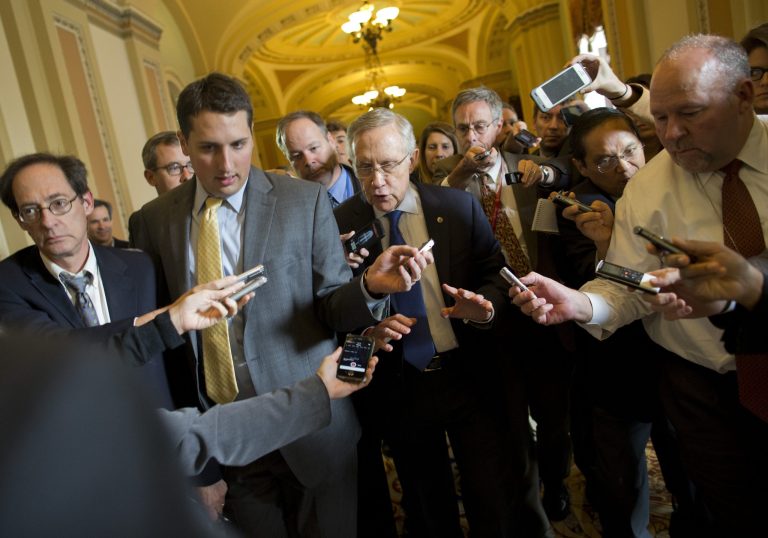 Senate Majority Leader Sen. Harry Reid, D-Nev., is surrounded by reporters after leaving the office of Senate Minority Leader Sen. Mitch McConnell, R-Ken., on Capitol Hill on Monday, Oct. 14, 2013 in Washington. Reid reported progress Monday toward a deal to avoid a threatened default and end a two-week partial government shutdown as President Barack Obama called congressional leaders to the White House to press for an end to the impasse. 