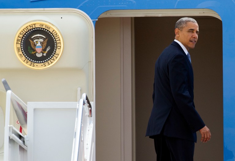 President Barack Obama looks back as he boards Air Force One at Andrews Air Force Base, Md. Tuesday, April 22, 2014, for a flight to Oso, Washington to visit with victims of the deadly March 22 disaster, emergency responders and recovery workers.  (AP Photo/Cliff Owen)